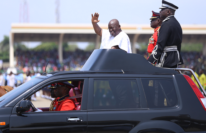 Bespectacled and sporting a beautiful white smock, the President waved to the cheering crowd, mounted the rostrum and took the national salute for the first time at an independence celebration. 